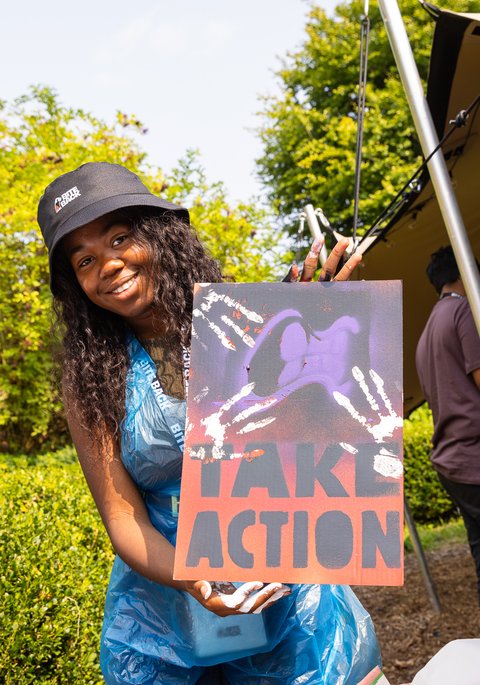 Derrin with a sign at the residential